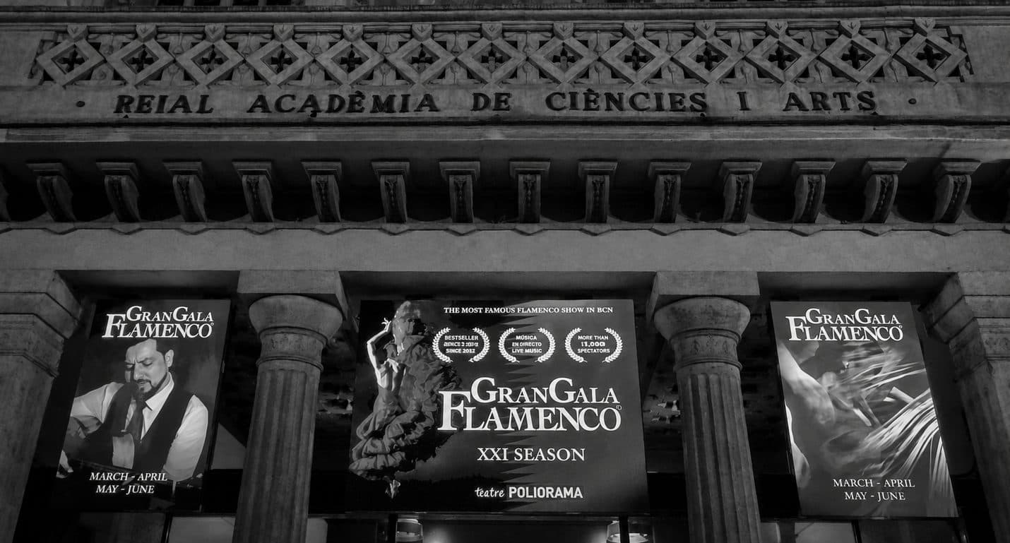 Gran Gala Flamenco posters for its XXI season mounted across the stone facade of the Reial Acadèmia de Ciències i Arts, home of Barcelona's Teatre Poliorama