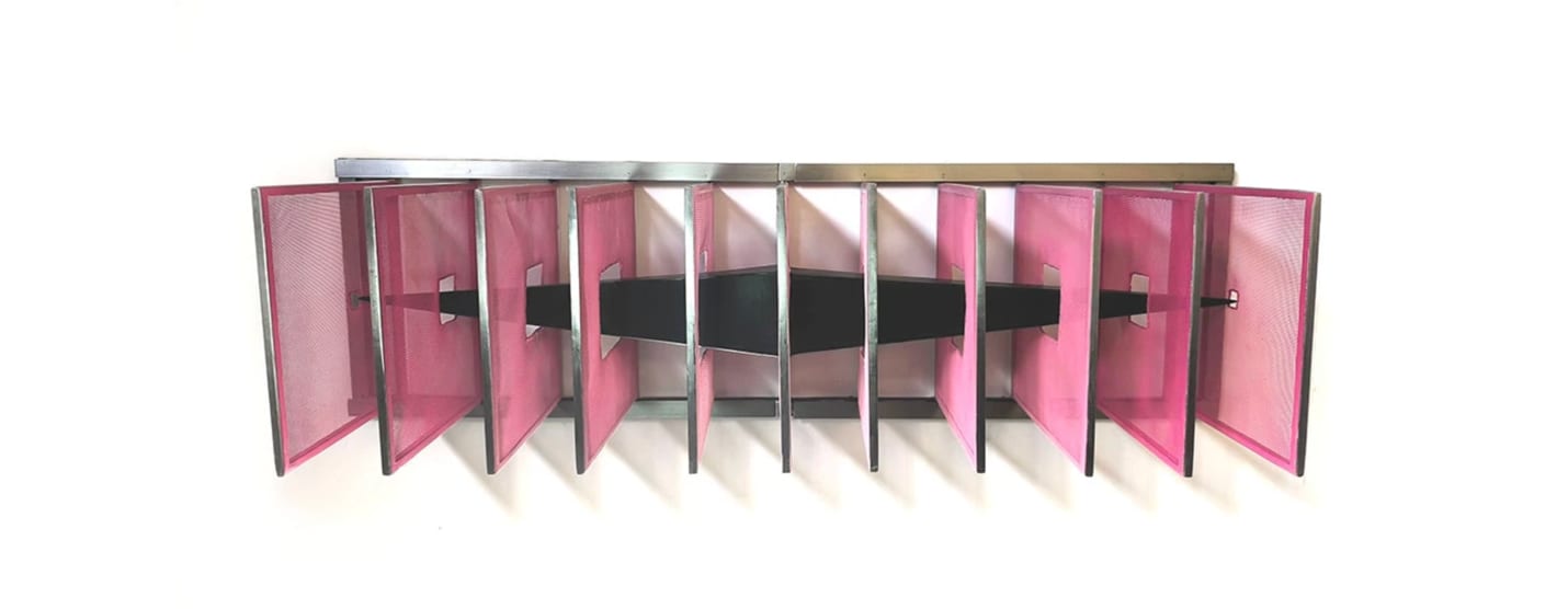 Vanesa Muñoz's abstract wall sculpture — a row of translucent pink mesh panels framed in steel, with a black band threading horizontally through the centre